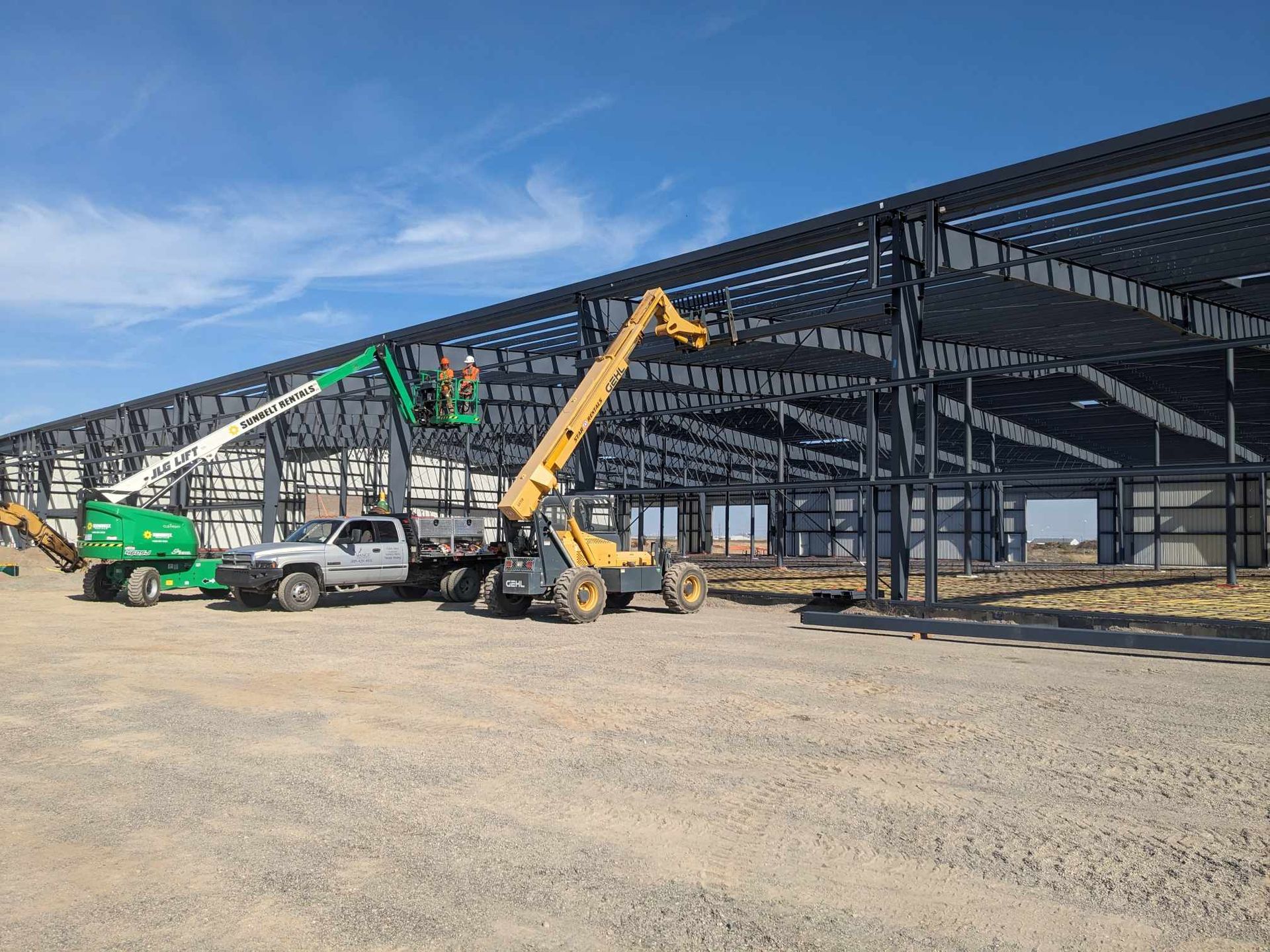 Crew erecting the structural steel frame of a large commercial building in Kettle Falls, WA